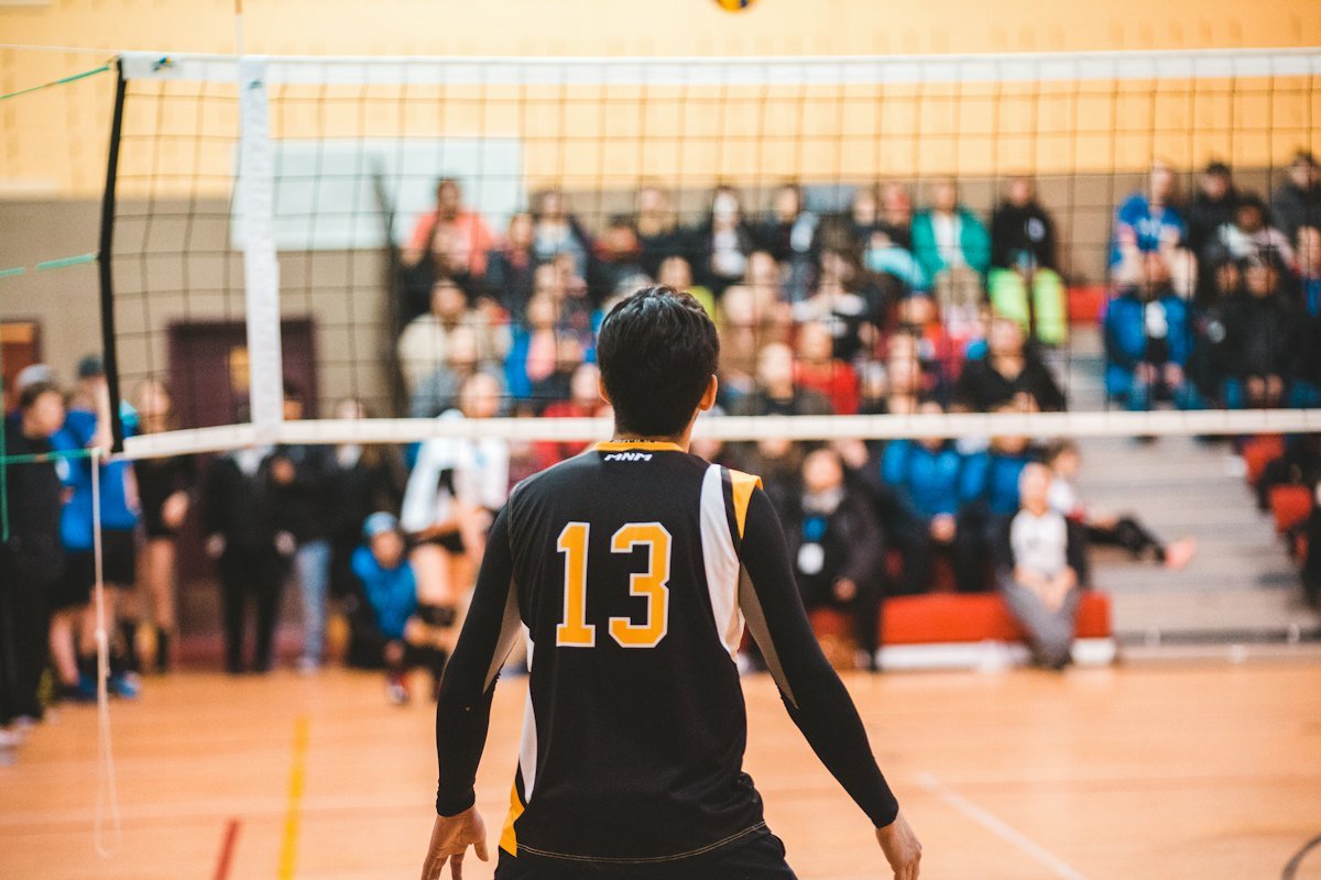 A player in a black number 13 jersey on court during a match